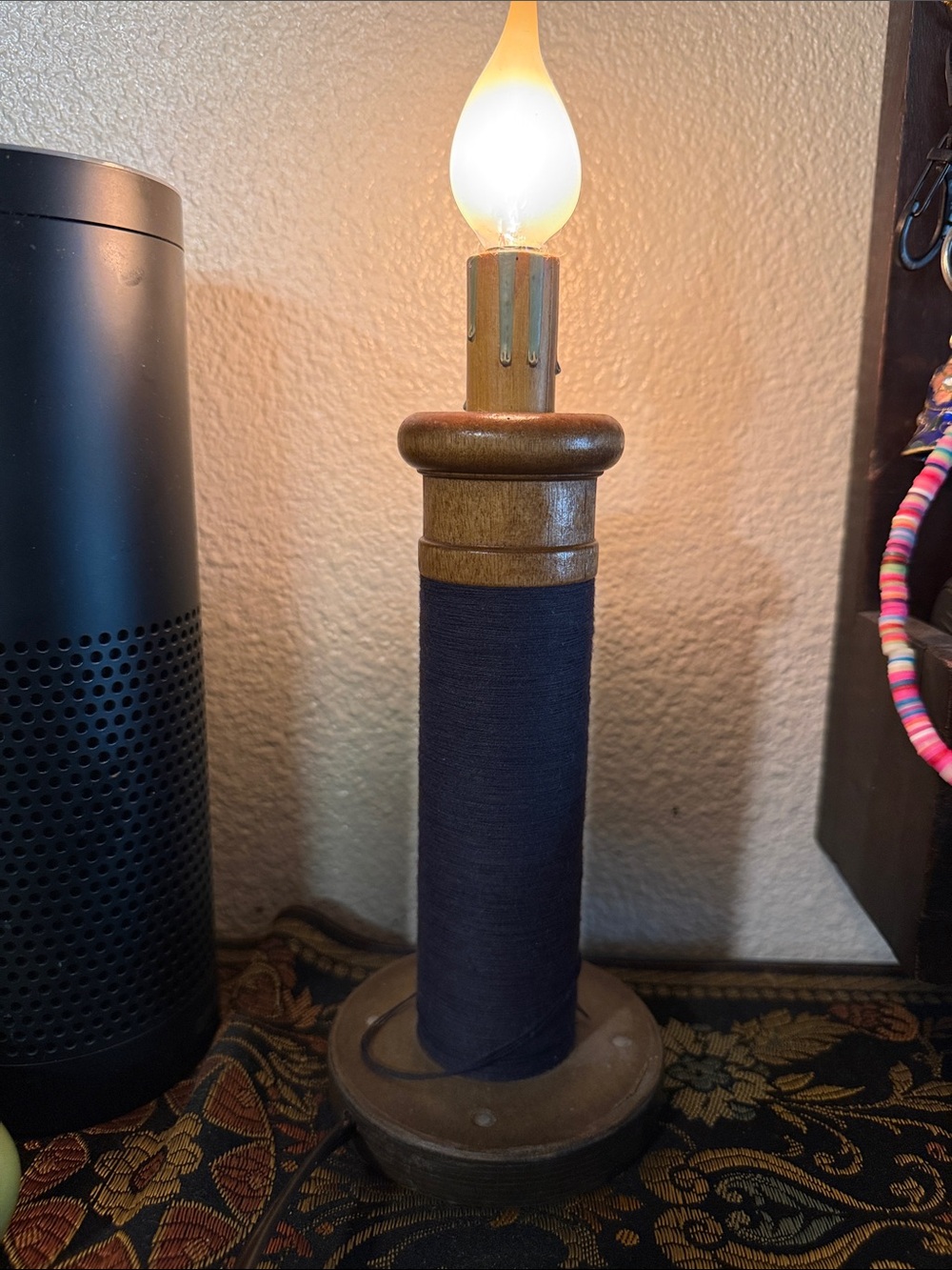 Wooden candlestick made to look like a spool of thread. 10 in.